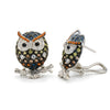 Pair of owl-shaped earrings with gemstones on a white background