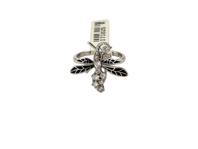 Silver ring with dragonfly design on a white background