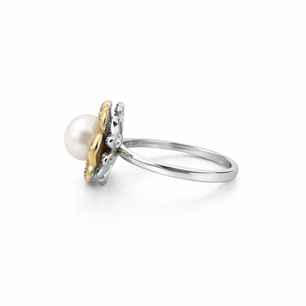 Silver ring with a pearl and gold accents - side view.