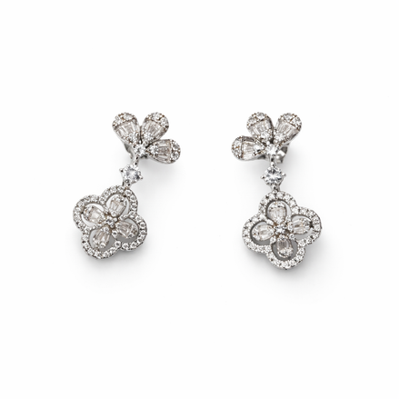 Clover-shaped silver earrings covered in cubic zirconia with varied cut shapes.