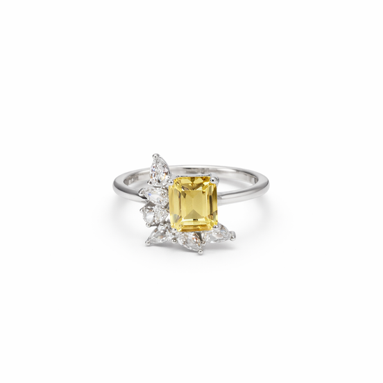 Ring with a yellow gemstone and cubic zirconia accents on a white background