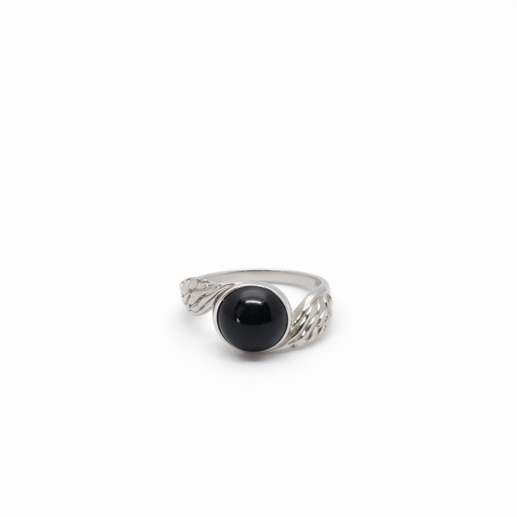 Silver ring with a black onyx stone on a white background